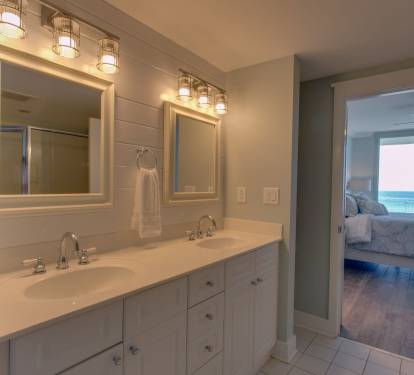 Catch the sunset from the master bathroom while getting ready to head out for dinner after a day on the beach.
