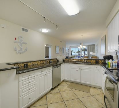 This fully equipped Destin beachfront condo kitchen makes family meals effortless after long days on the sugar white sands.