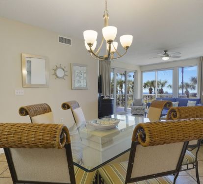 Coastal inspired living room with comfortable seating and direct access to the private beachfront balcony.