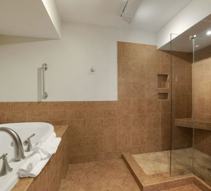 Elegant tile finishes and roomy design make this shared bathroom both comfortable and stylish for your Emerald Coast getaway.