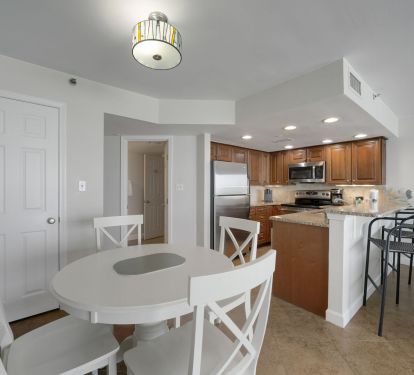 Enjoy the bright dining area and breakfast bar in Cabana Club 205 beachfront condo