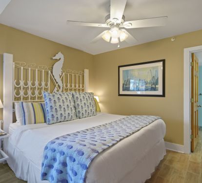 Elegant coastal bedroom with a King bed that is  designed for restful beach stays