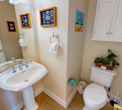 The additional half bath near the common area ensures that guests have ample space to refresh and rejuvenate.