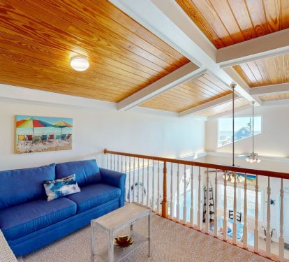 The upstairs loft, a cozy bonus space, is perfect for starting your day with a little cathartic reflection or winding down with a little quiet time after a day of fun in the sun.