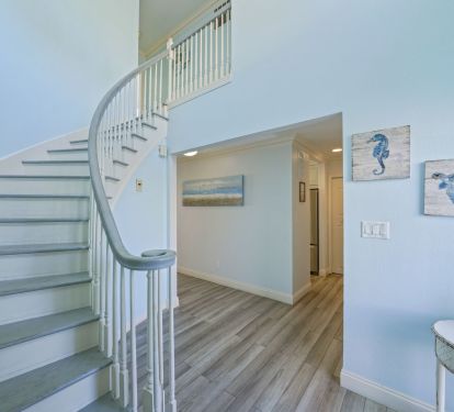 Step inside Captains Quarters and feel the shift instantly as this bright, open staircase leads you deeper into your private beachfront escape.