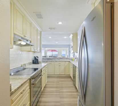 This beautifully updated kitchen makes gathering effortless, whether you are packing beach snacks, blending smoothies, or cooking a fresh seafood dinner.