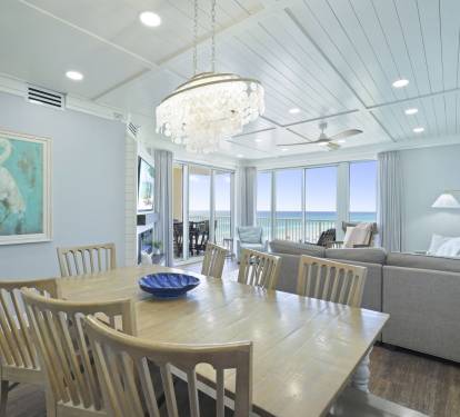 Dining room seating for 8 with 4 barstools looking into the living room
