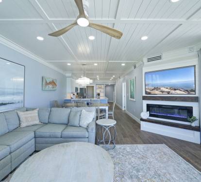 The beautiful living room and electric fireplace, looking into the kitchen