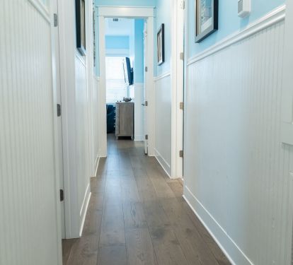 White trim and soft blue walls create a calming transition to the bedrooms.