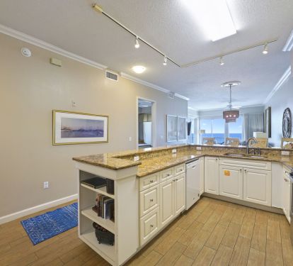 Airy open layout kitchen with island and ocean-view seating area