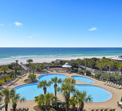 Destin beachfront condo balcony overlooking lagoon pool and white sand beach