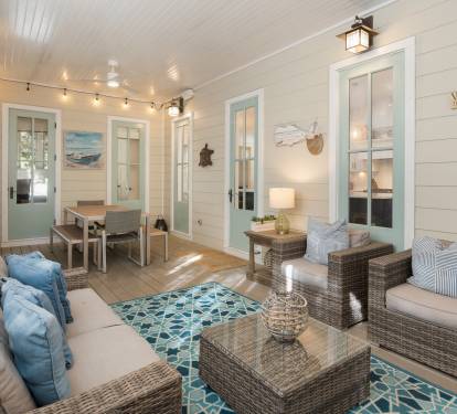 Unwind in your bright, coastal living space with wicker seating and cheerful blue accents that perfectly capture beach house charm.