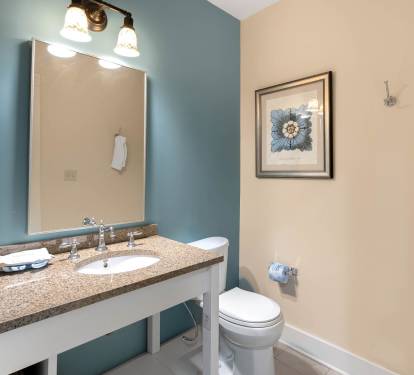 Fresh up in your coastal-themed bathroom with granite counters, elegant lighting, and soft towels waiting for you.