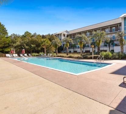 Your home away from home overlooks this sparkling pool where warm days blend into peaceful evenings under swaying palms.