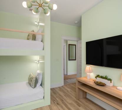 Relax in your custom bunk room with built-in beds, cozy reading lights, and entertainment center for family fun.