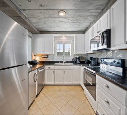 Your fully equipped kitchen features modern stainless steel appliances and granite counters, perfect for preparing family meals together.