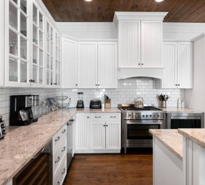 You'll love preparing meals in this stunning white kitchen with granite countertops, stainless appliances, and abundant cabinet space for all your needs.