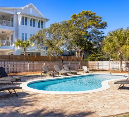 Sparkling pool surrounded by comfortable loungers invites you to soak up the sun in your private backyard oasis.