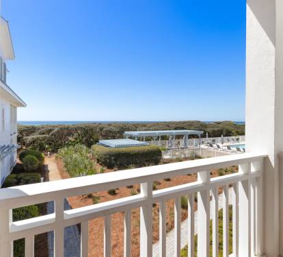 Step onto your private balcony and soak in stunning views of the sparkling pool and distant ocean horizon.