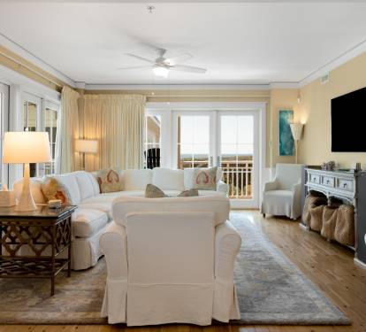 Settle into this elegant living room where plush white seating surrounds a chic coffee table, perfect for your morning coffee or evening conversations.