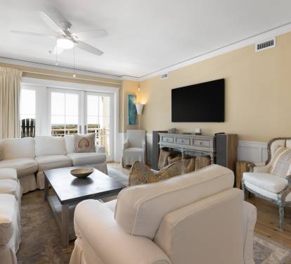 Sink into plush sofas in your elegant living room, where the fireplace adds warmth and large windows frame beautiful views.