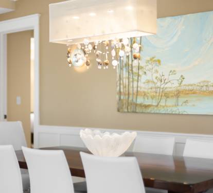 Gather around your elegant dining table where thoughtful touches and beautiful artwork create the perfect atmosphere for memorable meals together.
