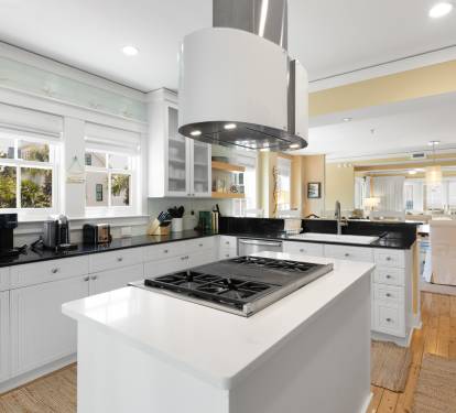 You'll love preparing meals in this stunning chef's kitchen, featuring premium appliances, elegant white cabinetry, and a spacious island perfect for cooking together.