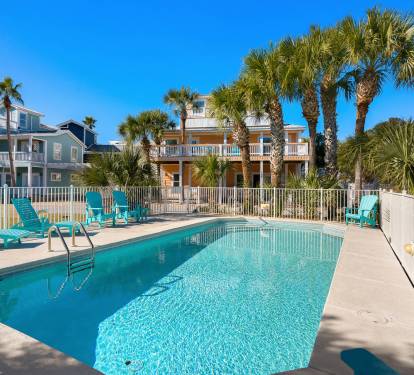 Dive into your shared oasis with crystal-clear waters and vibrant turquoise loungers under swaying palms.