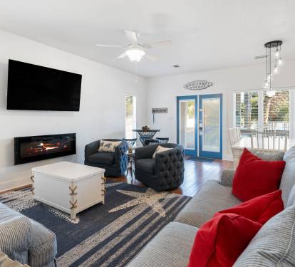 Sink into plush seating by the cozy fireplace while your favorite shows play on the wall-mounted TV—perfect for relaxing evenings together.