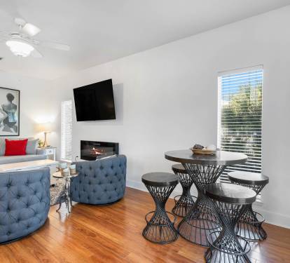 Relax in your stylish living space with cozy seating, modern fireplace, and intimate dining nook perfect for morning coffee or evening meals.