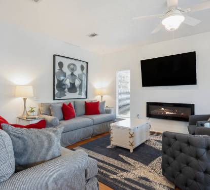 Sink into plush sectional seating while the fireplace crackles warmly. Your stylish retreat features modern comfort with thoughtful touches.