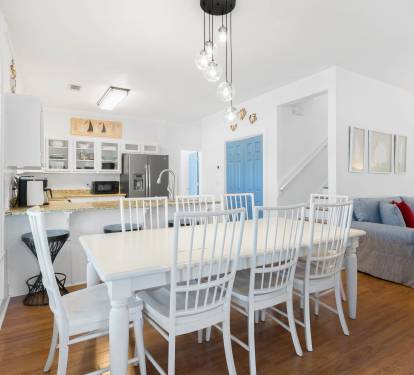Relax in this bright, open-plan living space where you can cook, dine and unwind together under stylish pendant lights.