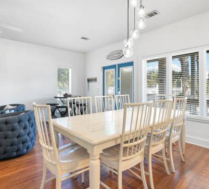Gather your group around this spacious dining table for memorable meals, with natural light streaming through large windows.