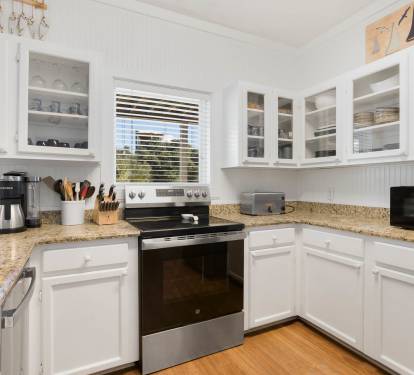 Your fully equipped kitchen features granite counters, glass-front cabinets, and everything needed to create memorable meals during your stay.