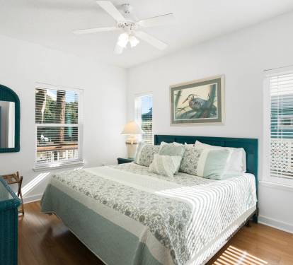 Step into your serene coastal bedroom where calming teal tones and natural light create the perfect retreat for peaceful nights.