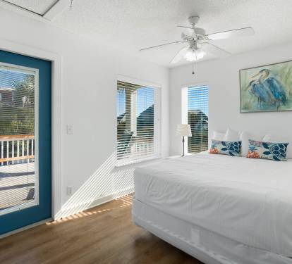 Drift off to sleep in your bright bedroom with coastal artwork and access to your private balcony.