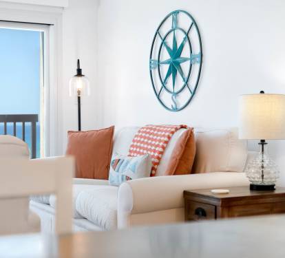 Sink into this coastal living room where gulf views meet comfort. Nautical touches and warm pillows create your perfect seaside retreat.