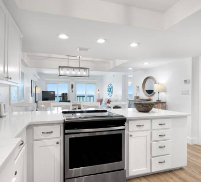 Your bright, modern kitchen invites culinary adventures with pristine white cabinets, sleek appliances, and an open flow to the living area.