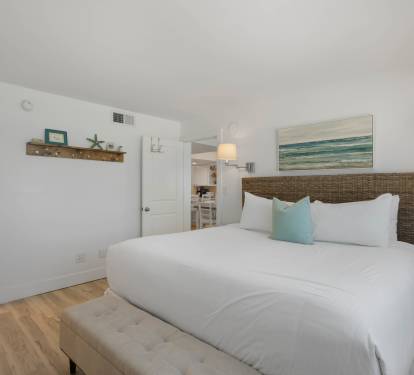 Drift off in your coastal-inspired bedroom with ocean artwork and soft linens creating the perfect beach getaway vibe.