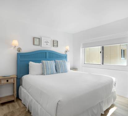 Sink into crisp white linens and let the coastal blue headboard transport you to seaside dreams in your peaceful retreat.