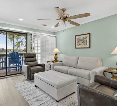 Unwind in your spacious living area with comfortable leather seating, tropical breezes from your private balcony, and soothing coastal views to enhance your relaxation.