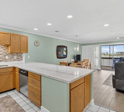 Open-concept living with a spacious kitchen featuring granite countertops and island, flowing seamlessly into your dining and living areas with balcony access.