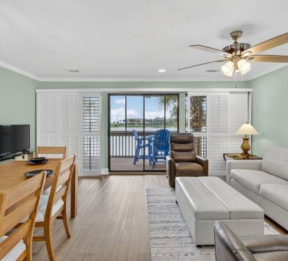 Relax in your bright, airy living space with comfortable seating, dining for six, and sliding doors that open to your private waterfront balcony.