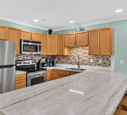 Your fully-equipped kitchen features granite countertops, stainless steel appliances, and a convenient breakfast bar where you can enjoy morning coffee or prepare meals together.