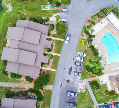 Aerial view of the neighborhood. Community pool directly across the parking lot from the unit.