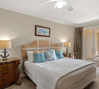 Rest peacefully in the coastal-themed bedroom with anchor-detailed lamps, plush linens, and a private balcony for morning coffee.