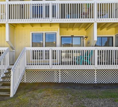 Back of condo. Steps leading to pool