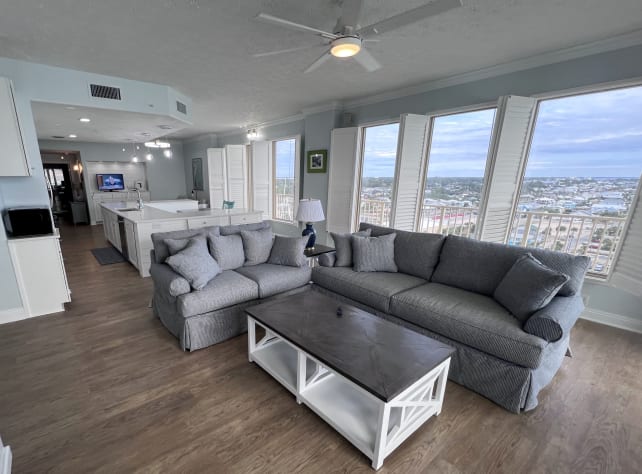 New living room furniture &amp; 65" TV on fireplace overlooking the Gulf