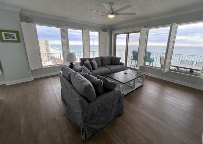 New living room furniture &amp; 65" TV on fireplace overlooking the Gulf