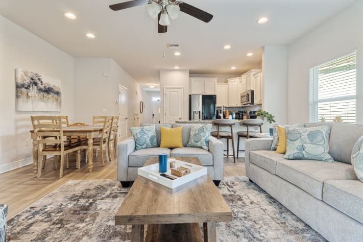 Bright, modern open-concept home with a cozy living area, stylish furnishings, and fully equipped kitchen. Enjoy comfortable seating, dining space, and natural light perfect for relaxing, working remotely, or hosting a memorable stay.